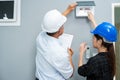 Senior home inspector checking home defects and teaching young engineers, before handing it over to client. Young engineers learn