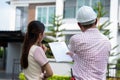 Senior home inspector explains Inspection results with homeowner, handyman holding clipboard and after checking details before