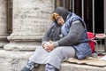 Senior homeless lady sleeping on the sidewalk in Rome, Italy Royalty Free Stock Photo