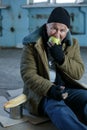 Senior homeless man eating an apple