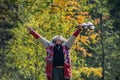 Senior homeless man with torn old sweater celebrating life