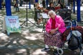 Senior homeless woman listens to music in a Seattle park