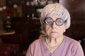 Senior humorous woman with old fashioned eyeglasses Royalty Free Stock Photo