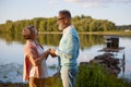 Senior husband confessing his love to wife during walk near river Royalty Free Stock Photo