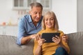 Senior Husband And Wife Using Digital Tablet Together At Home Royalty Free Stock Photo