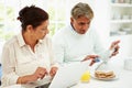 Senior Indian Couple Using Laptop And Digital Tablet At Home Royalty Free Stock Photo