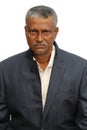 Senior Indian man cropped portrait view with angry or sad expression on white background. Royalty Free Stock Photo