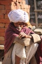 Senior Indian man sit on the street