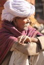 Senior Indian man sit on the street