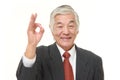 Senior Japanese businessman showing perfect sign Royalty Free Stock Photo