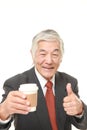 Senior Japanese businessman takes a coffee break