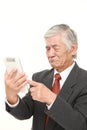 Senior Japanese businessman using tablet computer looking confused Royalty Free Stock Photo