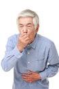 Senior Japanese man feels like vomiting Royalty Free Stock Photo