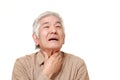 Senior Japanese man having throat pain