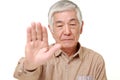 Senior Japanese man making stop gesture Royalty Free Stock Photo