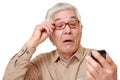 Senior Japanese man with presbyopia Royalty Free Stock Photo