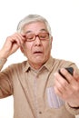 Senior Japanese man with presbyopia Royalty Free Stock Photo