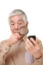 Senior Japanese man with presbyopia Royalty Free Stock Photo
