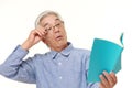 Senior Japanese man with presbyopia Royalty Free Stock Photo