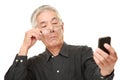 Senior Japanese man with presbyopia Royalty Free Stock Photo