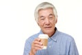 Senior Japanese man takes a coffee break Royalty Free Stock Photo