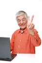 Senior Japanese man using laptop computer Royalty Free Stock Photo