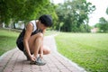 Senior jogger tighten her running shoe laces