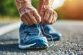 senior jogger tying shoelaces on running shoes