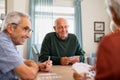 Senior joyful friends playing cards together Royalty Free Stock Photo