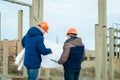 Senior and junior engineers discussing work together Royalty Free Stock Photo