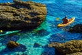 Senior kayaker on a kayak by the sea, active water sport and lei