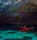Senior kayaker on a kayak by the sea, active water sport and lei