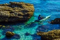 Senior kayaker on a kayak by the sea, active water sport and lei