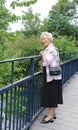 Senior lady on bridge Royalty Free Stock Photo
