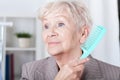 Senior lady combing hair Royalty Free Stock Photo