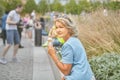 Senior lady eats ice cream in park