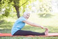 Senior lady enhancing body flexibility by stretching