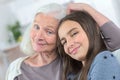 Senior lady with granddaughter happy together in domestic environment