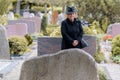 Senior lady in mourning at a graveside