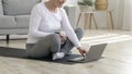Senior Lady Preparing For Training At Home, Browsing Online Tutorials On Laptop Royalty Free Stock Photo