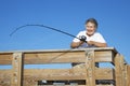 Senior Lady Reels in Fish Royalty Free Stock Photo