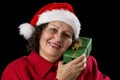 Senior Lady with Santa Claus Hat and Wrapped Gift Royalty Free Stock Photo