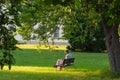 senior lady sitting on park bench