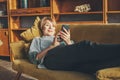 Senior lady with smart phone resting at home Royalty Free Stock Photo