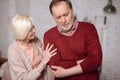 Senior lady taking care of husband with stomachache Royalty Free Stock Photo
