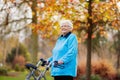 Senior lady with a walker in autumn park Royalty Free Stock Photo