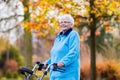 Senior lady with a walker in autumn park Royalty Free Stock Photo