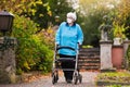 Senior lady with a walker in face mask Royalty Free Stock Photo