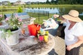 Senior lady watering her newly potted plants Royalty Free Stock Photo