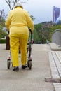 senior lady in yellow dress with rollator